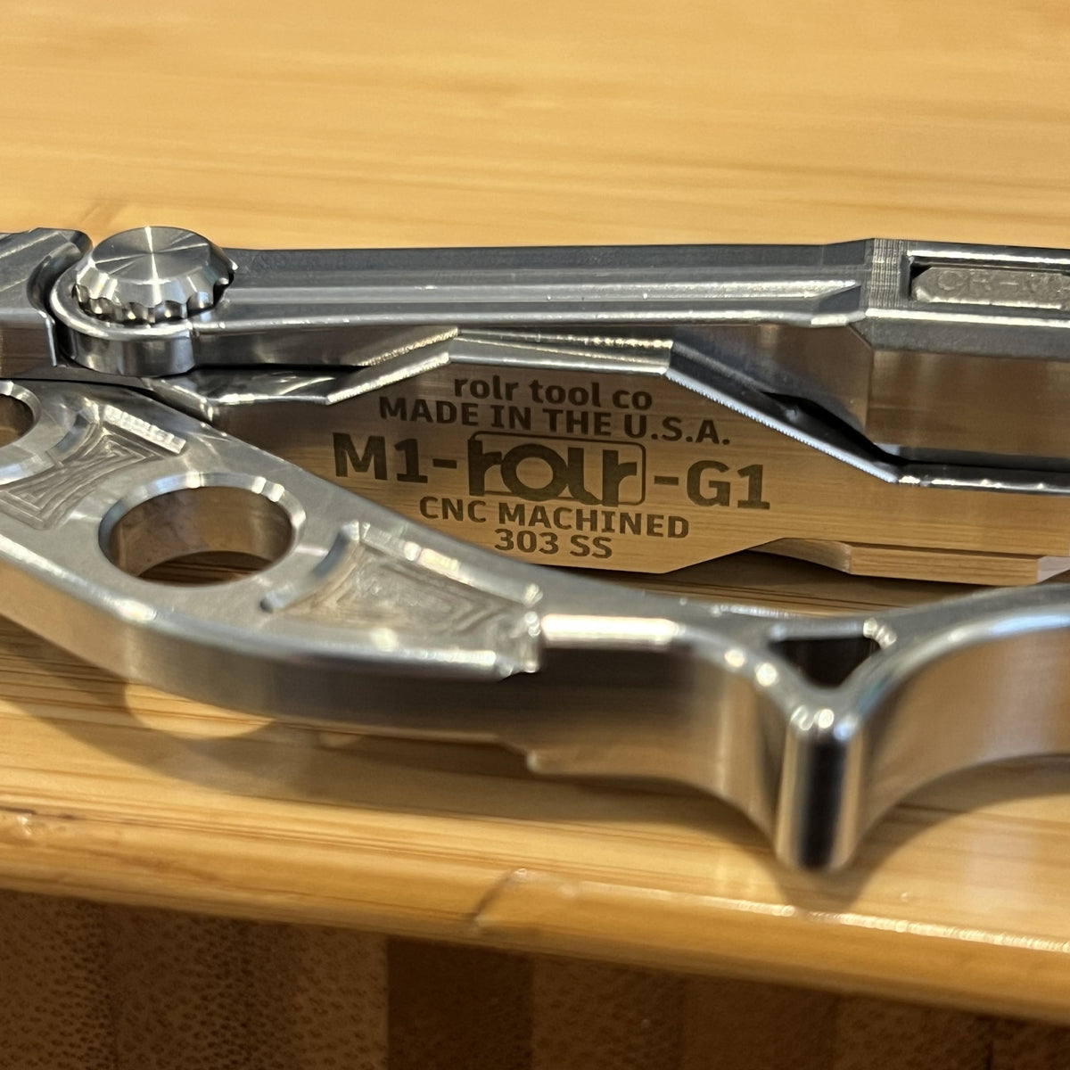 Closeup of ingraved steel multi tool